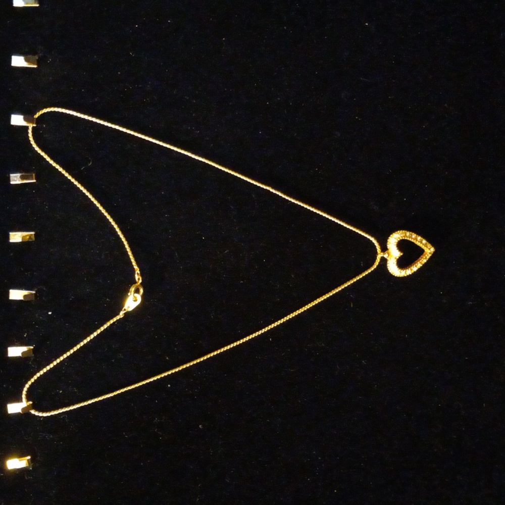 Vintage Avon crystal encrusted heat pendant on a 15 inch necklace.